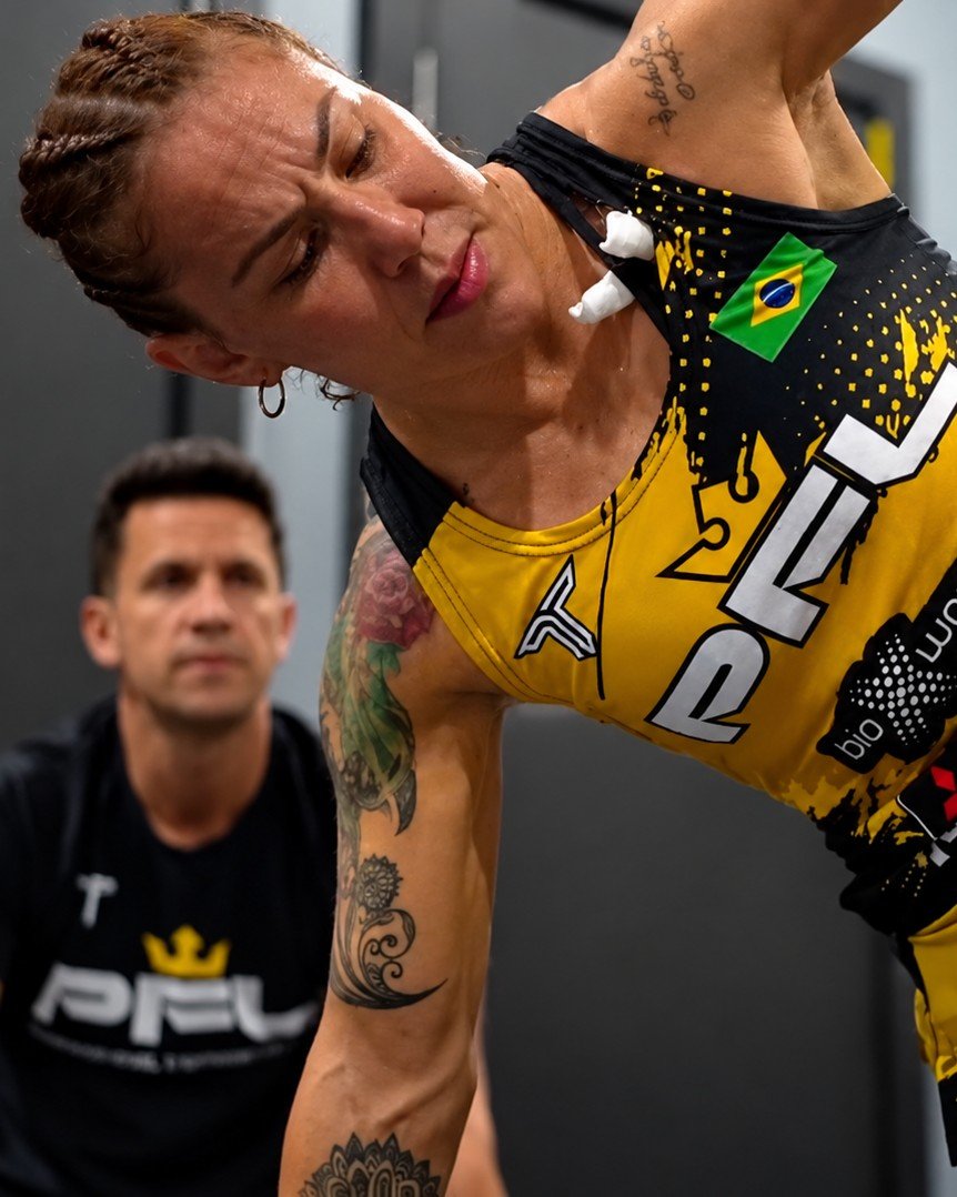 Ivan Carmosino coaching Cris Cyborg through a mobility session